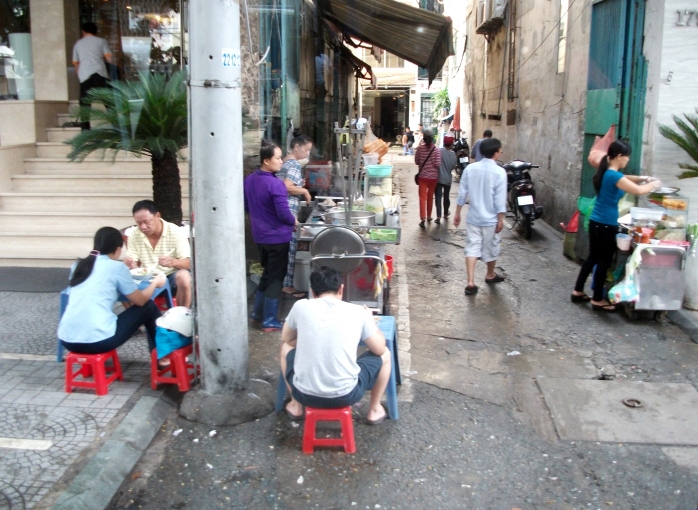 Breakfast Vietnamese style. Sitting on the street in mini stools eating Pho and drinking Vietnamese coffee.